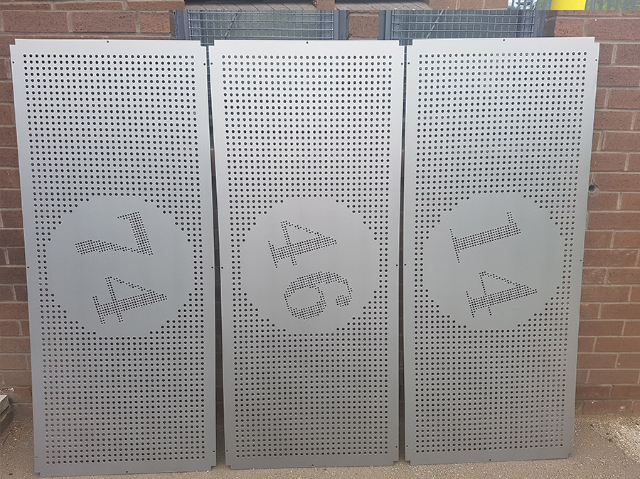 Perforated sheets of metal in grey steel with numbers